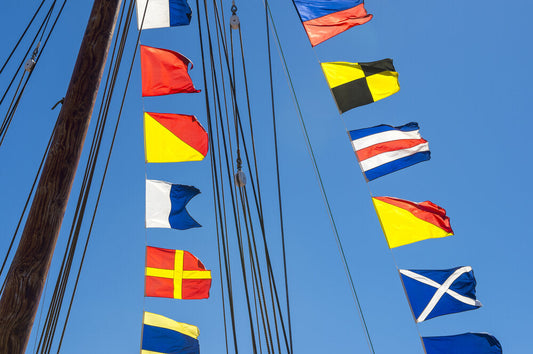 nautical flags hoisted on a ship